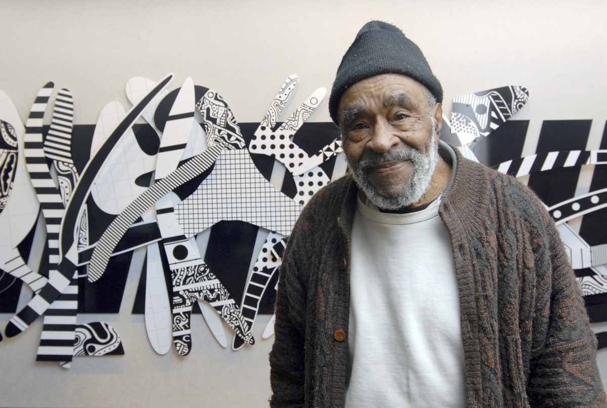 Charles McGee in front of <em>Regeneration</em>, 2007. Ultraviolet cured inkjet paint on Dibond, 78" X 264".