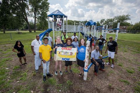 Members of Great Communities Now pose by a playscape Members of Great Communities Now pose by a playscape