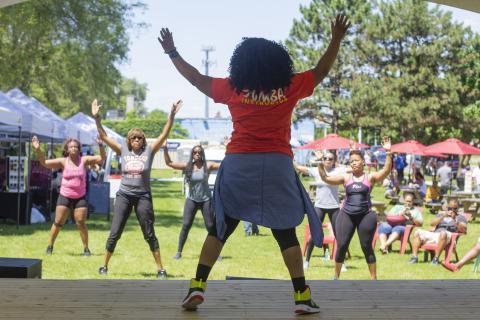 Detroit Market on the Ave Zumba fitness instructor leads class in outdoor recreation area