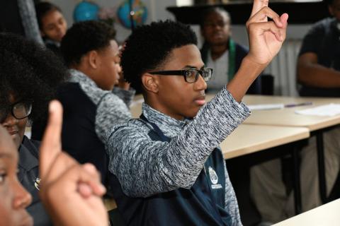 Getting down to business on the first day of class. Students raise hands on first day of class.