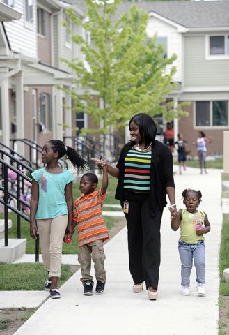 hamilton-crossing-banks-children.jpg Woman holding hands with her three children