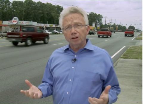 health-jackson-threat-from-roads.jpg Dr. Richard Jackson talking beside a busy street