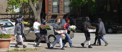lincoln-park-green.jpg People carry trays of flowers across street