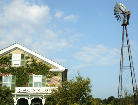 melvin-windmill-farmhouse.jpg Melvin Troyer of Sugarcreek, Ohio, works on one of the windmills on Kresge's headquarters campus.