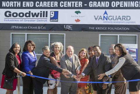North End Career Center ribbon-cutting Mike Duggan -- with officials from Goodwill Detroit, Vanguard CDC, Kresge, Detroit LISC and JPMorgan Chase surrounding him -- holds oversize scissors to symboblic ribbon at new North End Career Center