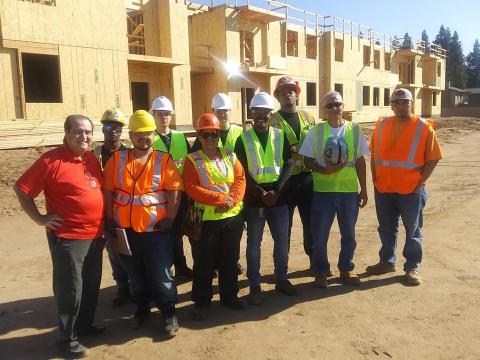 South East Fresno EDC organizes workforce development training for neighborhood residents South East Fresno EDC organizes workforce development training, residents pose for photo at construction site wearing hard hats.