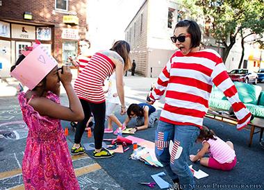 sidewalk7a_lg.jpg Little girl playing and taking pictures of woman