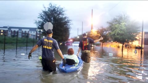 Rescue workers assisting residents in flooded area Photo of rescue workers assisting residents in flooded area