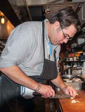 win-win-kulin-froelich_.jpg Man chopping up food in kitchen