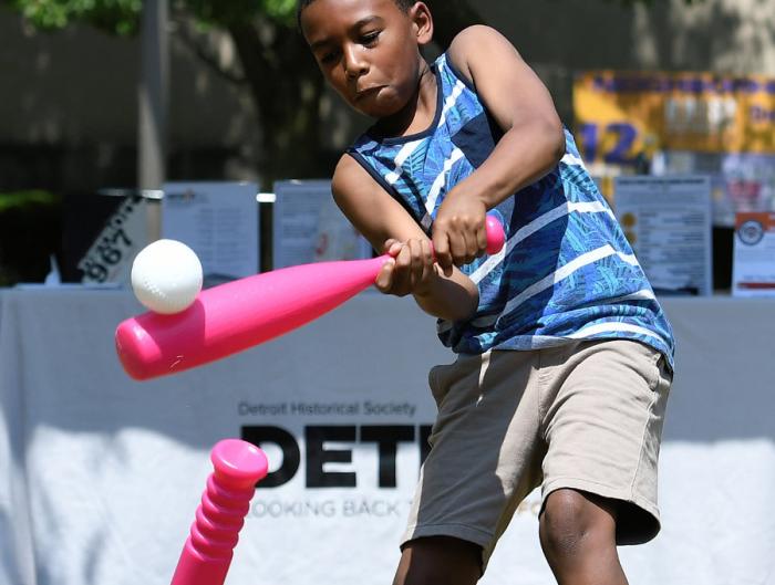 Kingston Brooks, 8, blasts a ball off the tee while playing a little ball on the lawn of the Detroit Public Library during the12th Annual ARISE Detroit! Neighborhoods Day. 