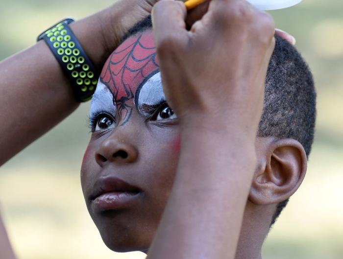 Ralphielle Hill, 6, gets his face painted on the lawn of the Detroit Public Library during the12th Annual Arise Detroit Neighborhood's Day.
