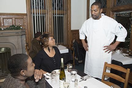 Chef Clinton Moore talking with two diners at the Gathering restaurant