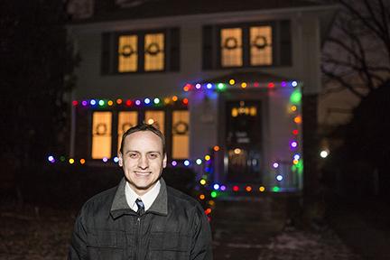 Joe Kvoriak in front of home with Christmas lights in Grandmont-Rosedale 