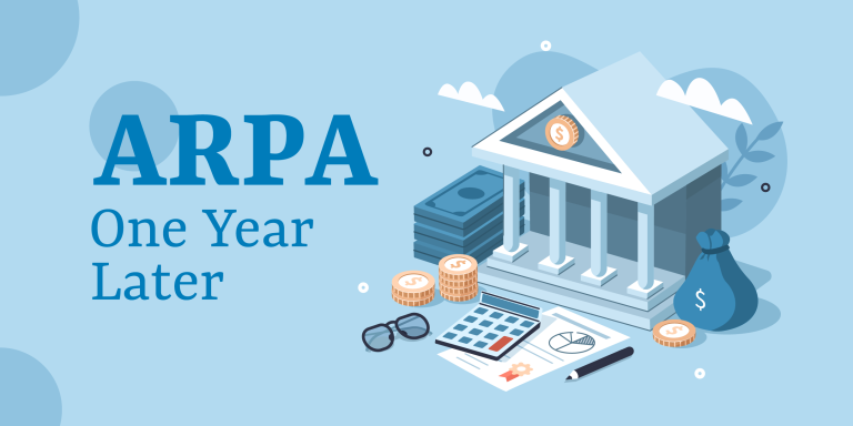 Light blue background. Graphic of a bank with money piled in front of it, and glasses, a pencil and a calculator. Words read: ARPA One Year Later