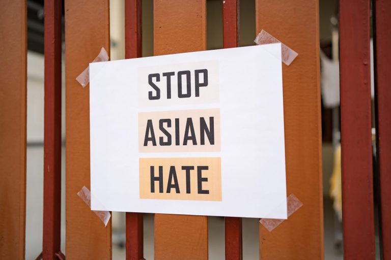 A photo of a sign on a fence that says: Stop Asian Hate