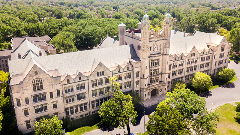 The Liberal Arts building on the Marygrove campus is a historic, Tudor Gothic structure with arched doorways and stained-glass windows.