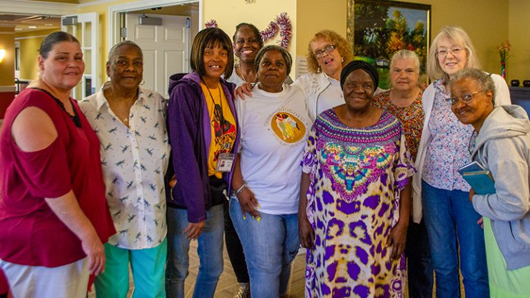 Ten residents of a housing complex are gathered together in an apartment.