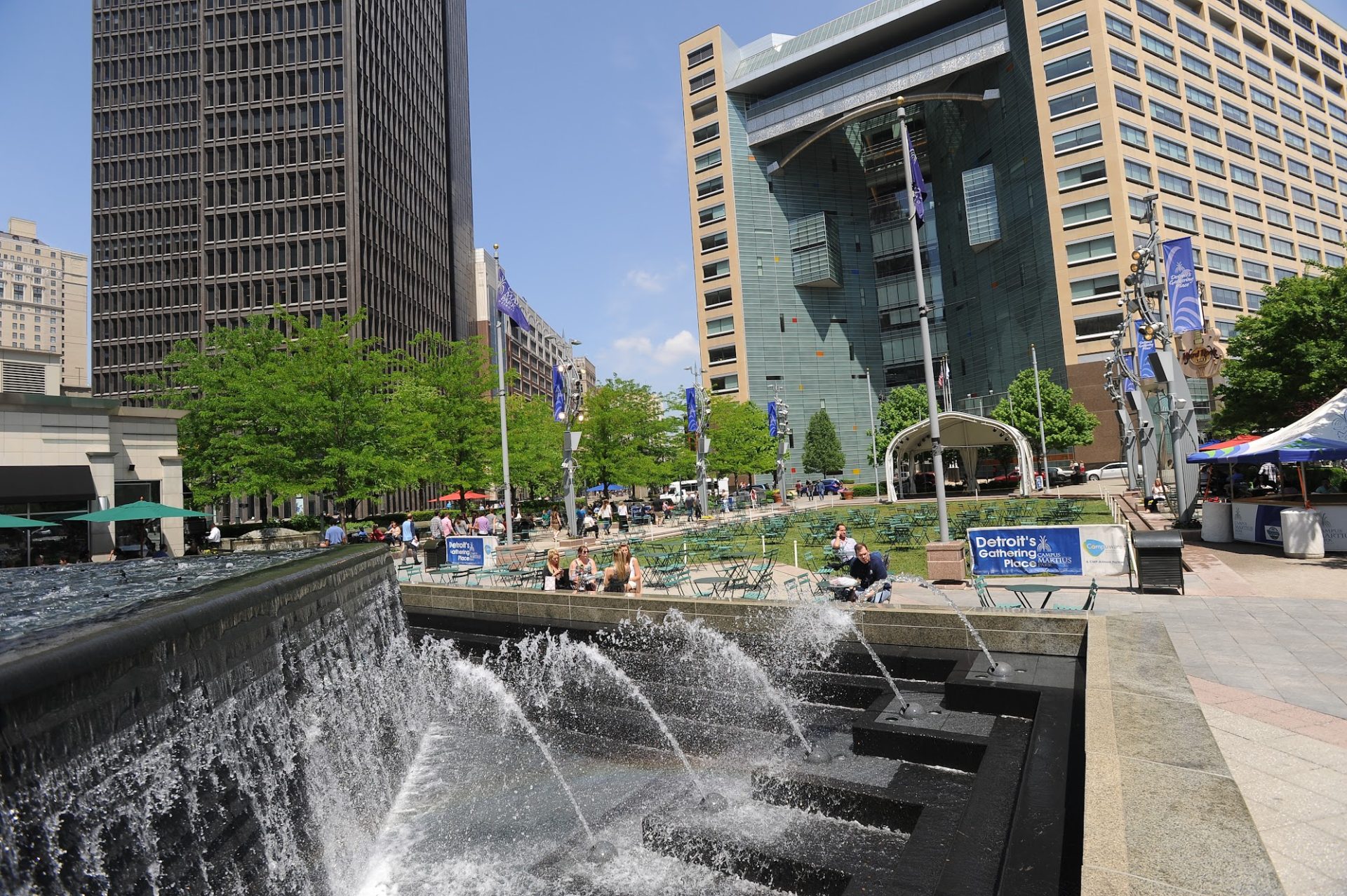 Detroit's Campus Martius, a downtown urban park with fountains, and green surrounded by downtown skyscrapers. 