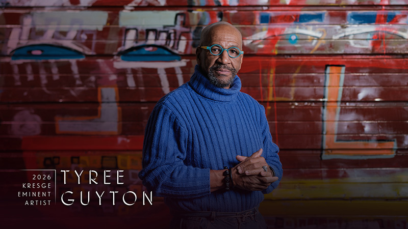 2026 Kresge Eminent Artist Tyree Guyton stands in front of one of his colorful paintings.