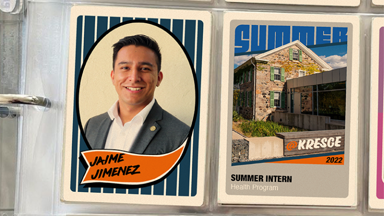A binder with two vintage-style baseball cards in plastic inserts. The first card on the left features a photo of a student intern in a grey suit coat, smiling and their name: Jaime Jimenez. The second card features a photo of a brick farmhouse and a connecting modern building with windows and the text: @Kresge 2022 | Summer Intern | Health Program.