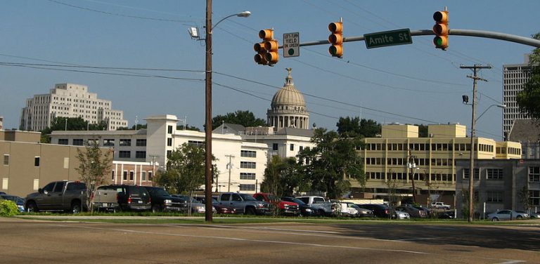 A photo of downtown Jackson Mississippi with the state capitol dome in the background.