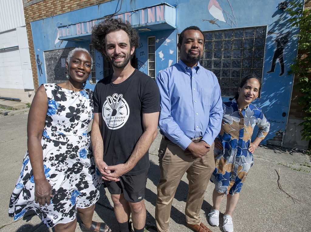 Four leaders of the Detroit Sound Conservancy stand in front of the Blue Bird Inn