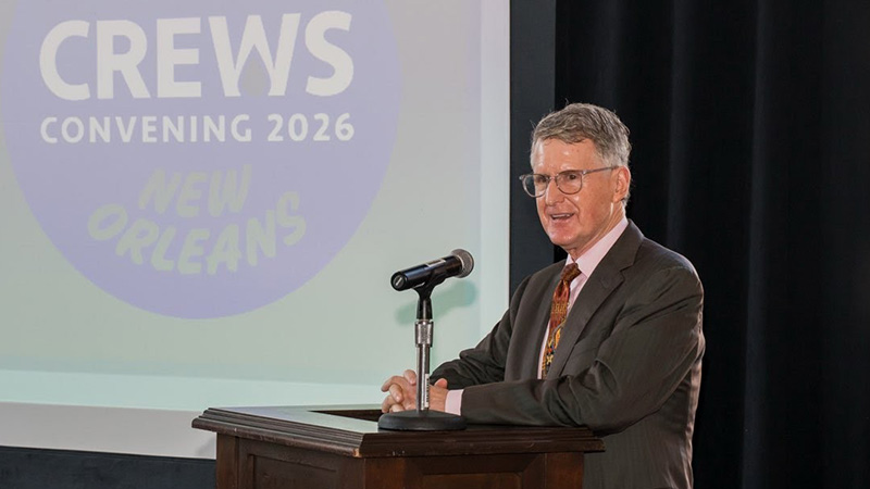 Kresge President Rip Rapson standing behind a podium gives a speech with a screen behind him that reads: CREWS Convening 2026 - New Orleans