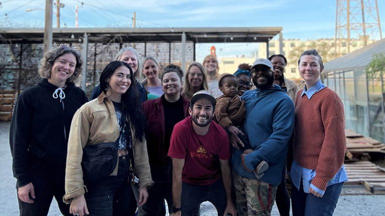 A group of volunteers help out at a community food program.