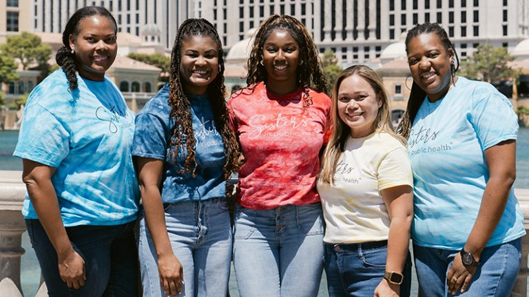 Five women wearing T-shirts that say Sisters in Public Health