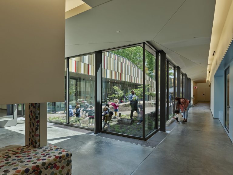 Hallways in the building run alongside an interior courtyard where children and staff play.
