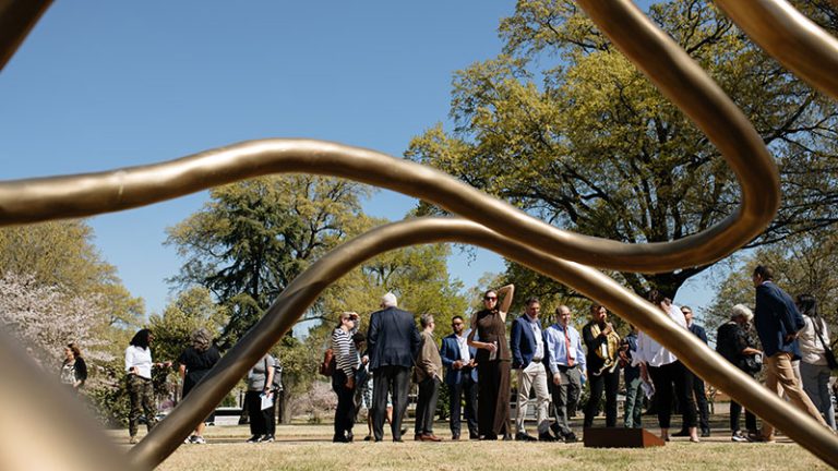 A group of people on a tour explore a park in Memphis.
