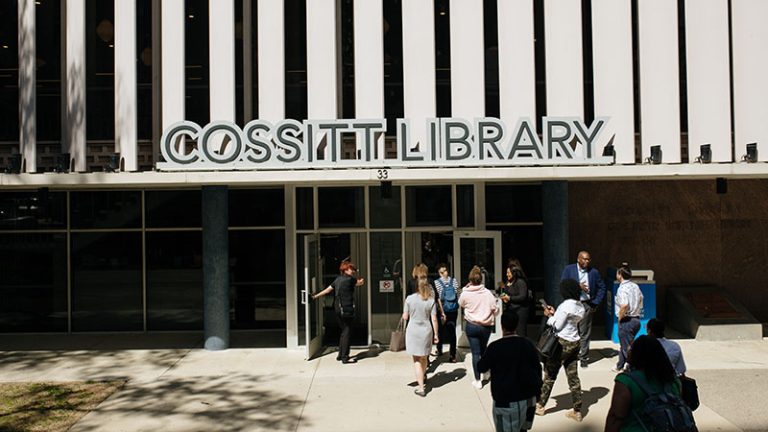 People on a tour enter the front door of the Cossitt Library