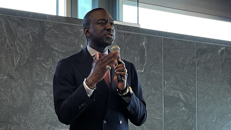 Dr. Yusef Salaam holds a microphone as he discusses his life's journey.