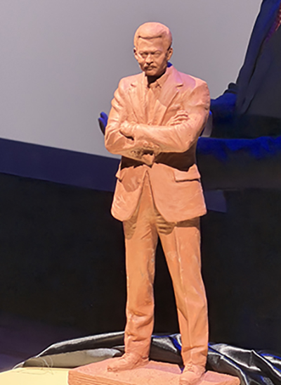 A sculptural model of the Coleman A. Young statue show Young standing with his arms crossed.