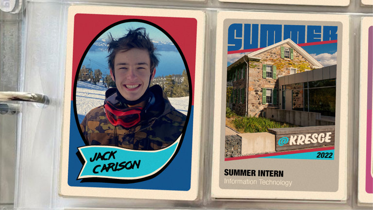 A binder with two vintage-style baseball cards in plastic inserts. The first card on the left features a photo of male student intern and his name: Jack Carlson . The second card features a photo of a brick farmhouse and a connecting modern building with windows and the text: @Kresge 2022 | Summer Intern | Information Technology