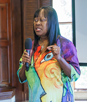 Kresge Human Services Managing Director Raquel Hatter in a multi-colored abstract dress. 